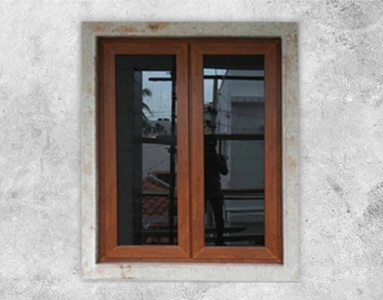 A rustic window featuring a wooden frame and unique brown glass for a warm ambiance